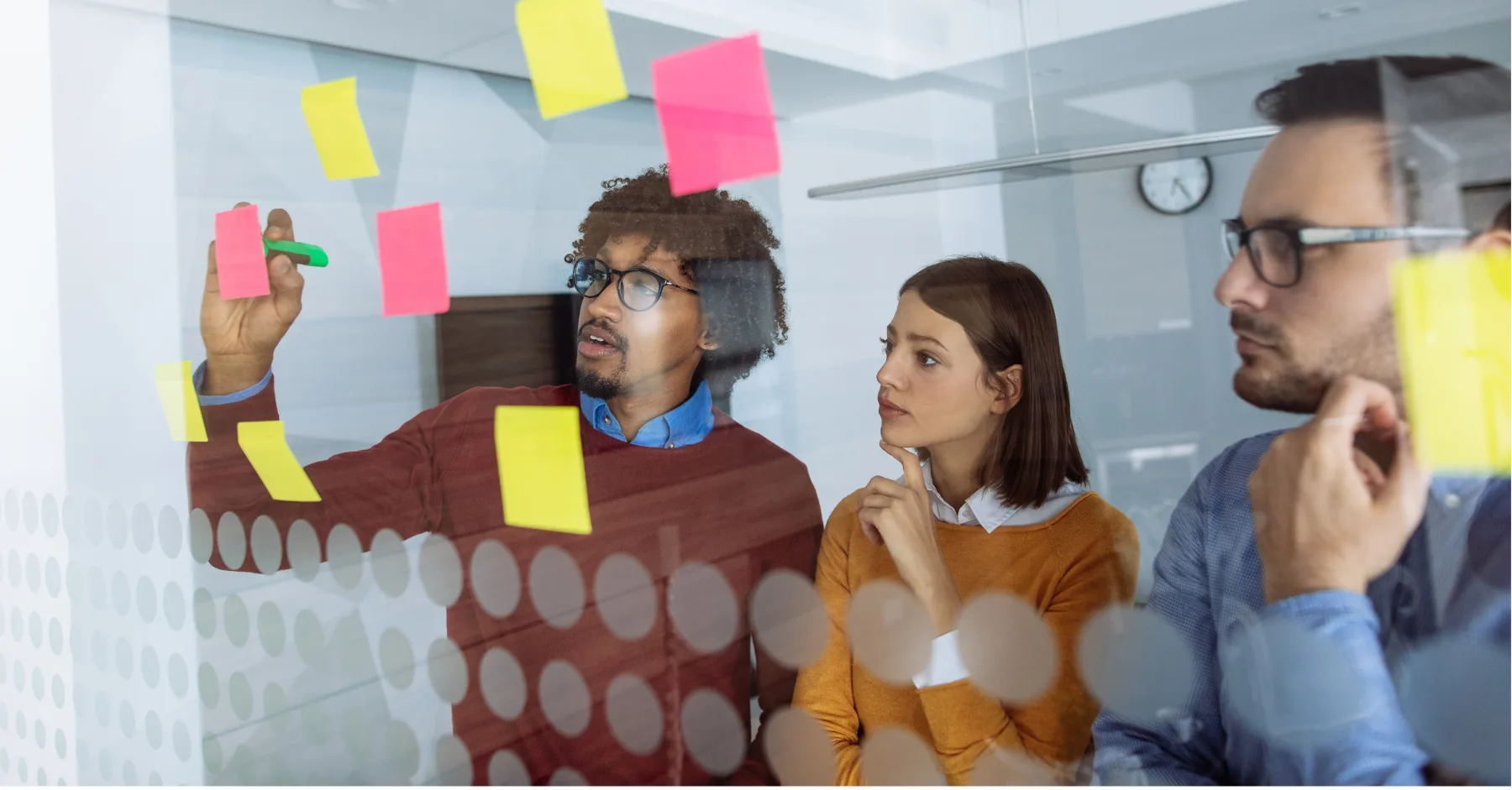 Marketers using post it notes on board