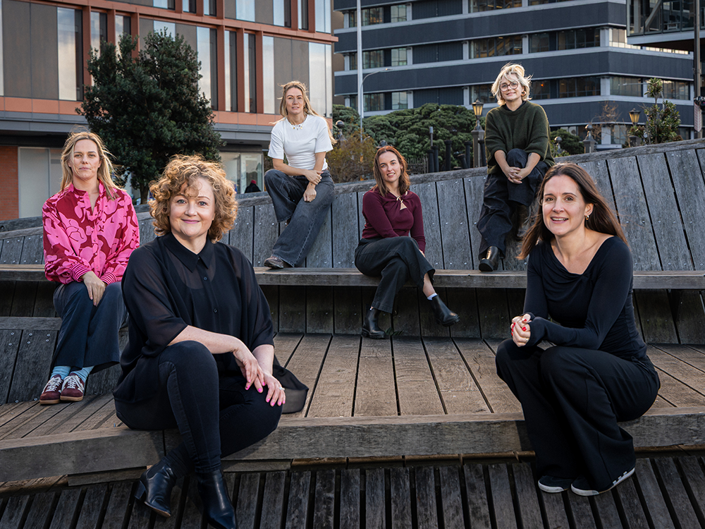 Virtual Marketers team sitting together outdoors - NZ based marketing specialists and outsourced marketing