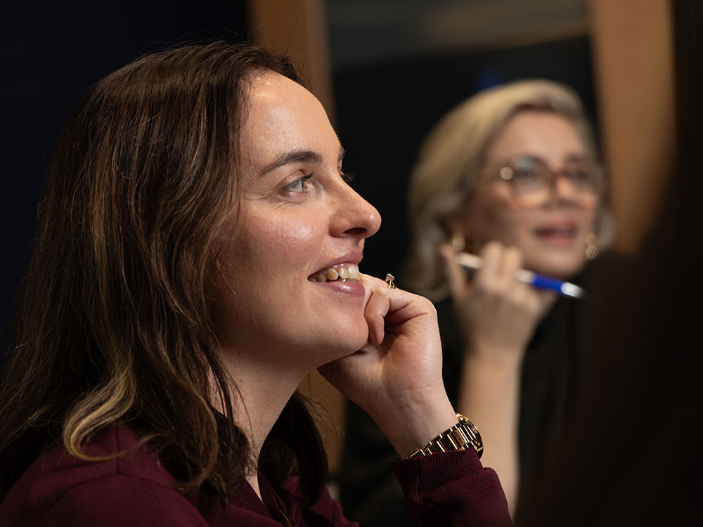 Marketer smiling while chatting with a colleague - Professional social media management services