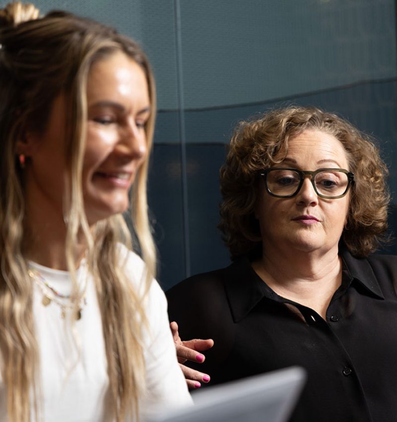 Two Virtual Marketers team members discussing ideas in the studio - Brand development and identity design services