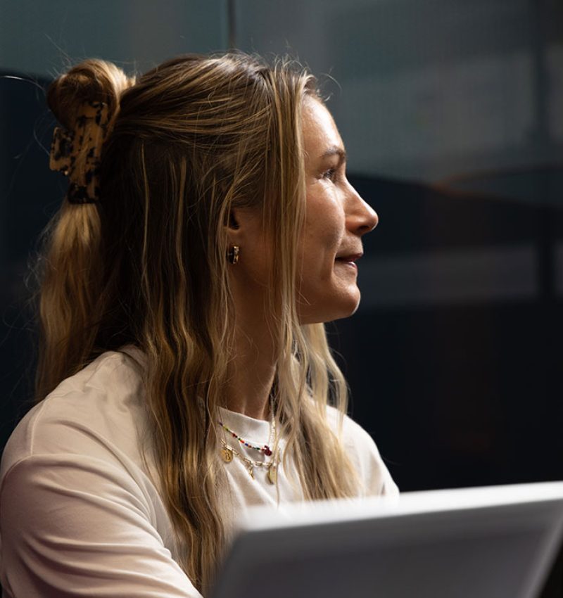 Marketer smiling during a planning conversation in the studio - Website design and development agency NZ