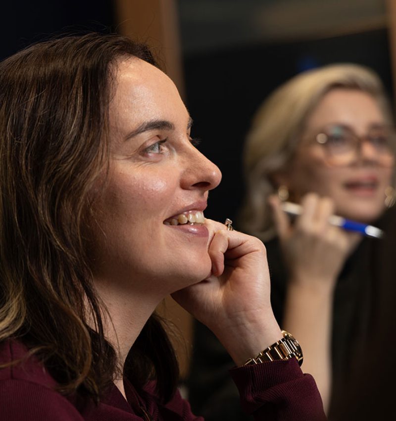 Marketer smiling while chatting with a colleague - Professional social media management services